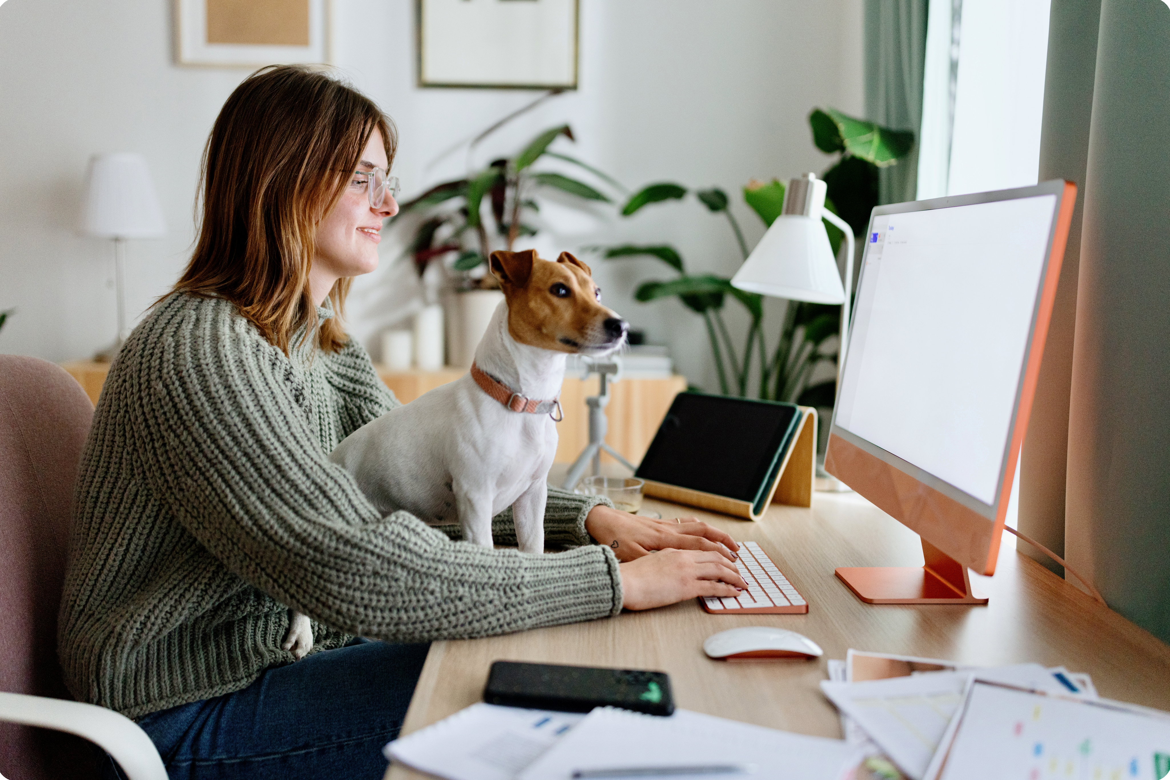 Woman with dog in front of computer